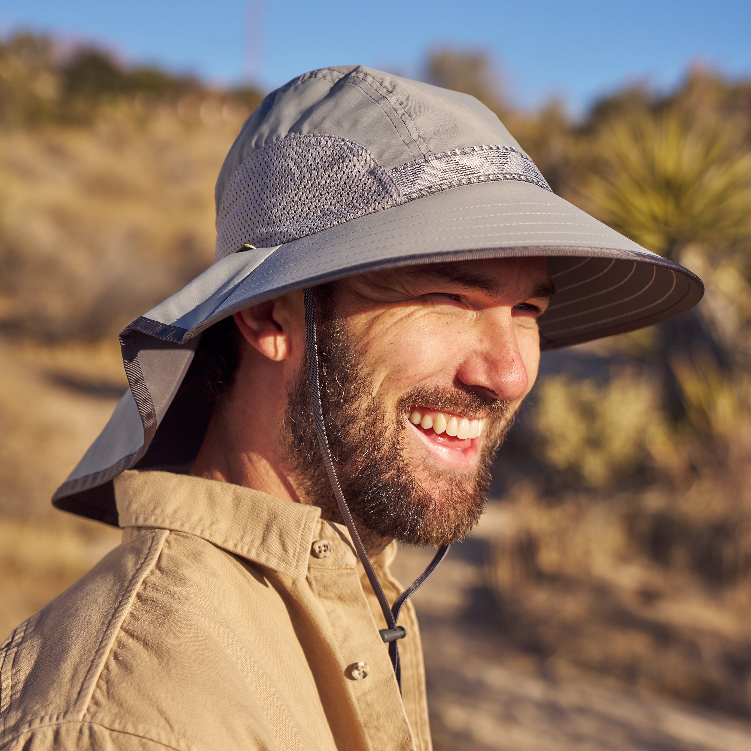 A man in a desert setting wearing a Sunday Afternoons Adventure hat in the color Quarry.